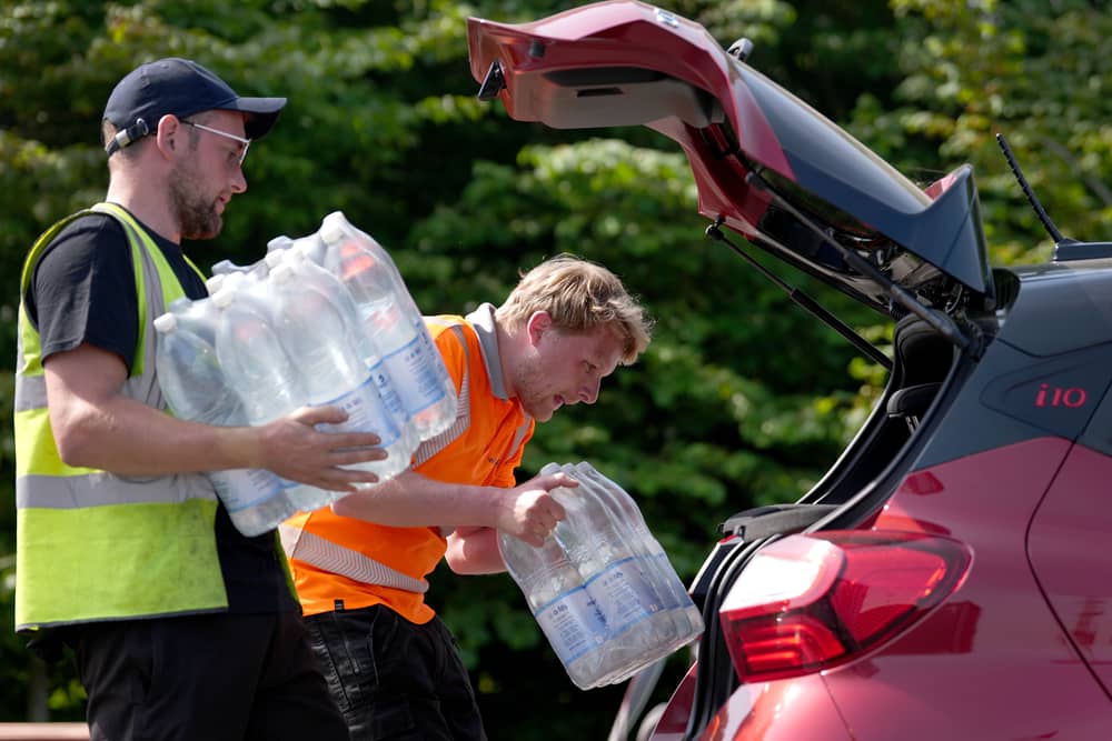 South east water staff hand out bottled water at a water collection point near Herne Bay in Kent