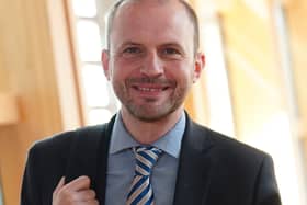 Stephen Gethins smiling in a Holyrood corridor