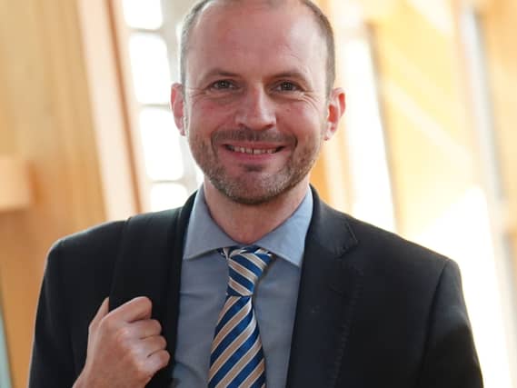 Stephen Gethins smiling in a Holyrood corridor