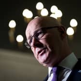 John Swinney cocking his head to one side as he speaks