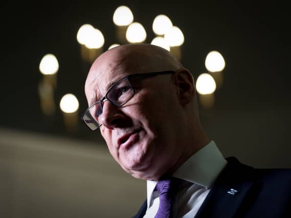 John Swinney cocking his head to one side as he speaks