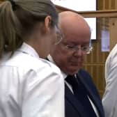 Peter Murrell flanked by security officers in court