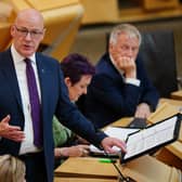 John Swinney standing while speaking in Holyrood
