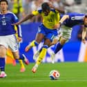 Sweden’s Anthony Elanga, left, and Japan’s Ao Tanaka battle for the ball