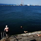 People enjoy the sunshine on the Bull Wall in Dublin