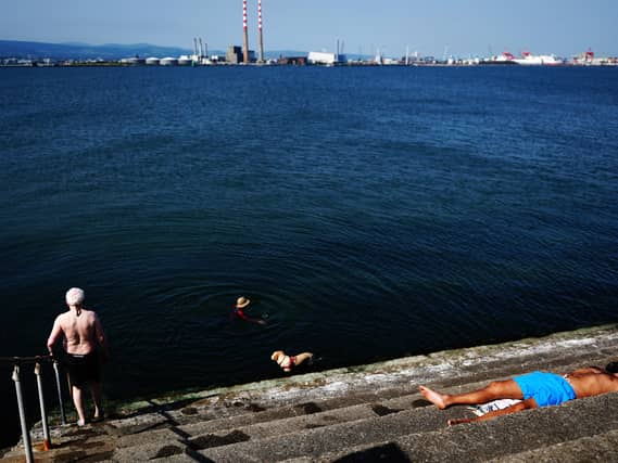 People enjoy the sunshine on the Bull Wall in Dublin