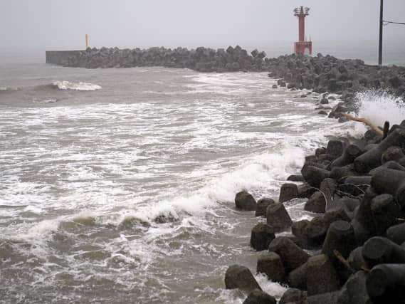 A coastline is hit by high waves as a typhoon approaches Futtsu city