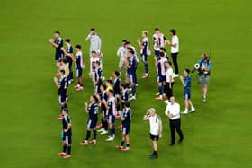 Steve Clarke and players on the pitch after Scotland's match against Brazil