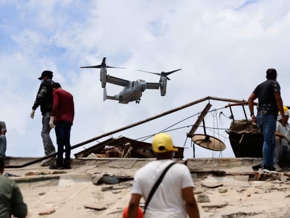 A US aircraft flies over an area struck by earthquakes in La Guaira, Venezuela