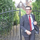 Andy Burnham going through gates