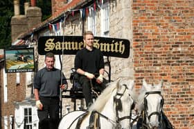 Kegs of beer being delivered to local pubs by a horse drawn cart from the Samuel Smith Old Brewery in Tadcaster