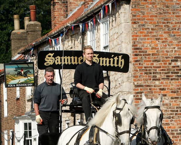 Kegs of beer being delivered to local pubs by a horse drawn cart from the Samuel Smith Old Brewery in Tadcaster