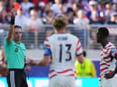 Referee Raphael Claus of Brazil shows a red card to United States’ Folarin Balogun, right, during the win over Bosnia (AP Photo/Julio Cortez)