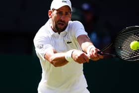 Novak Djokovic hits a backhand
