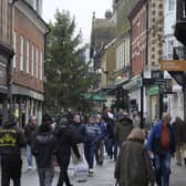 Shoppers make their way along a high street