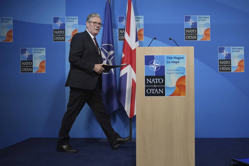 Keir Starmer walks towards a lectern to hold a press conference at the 2025 Nato summit in The Hague