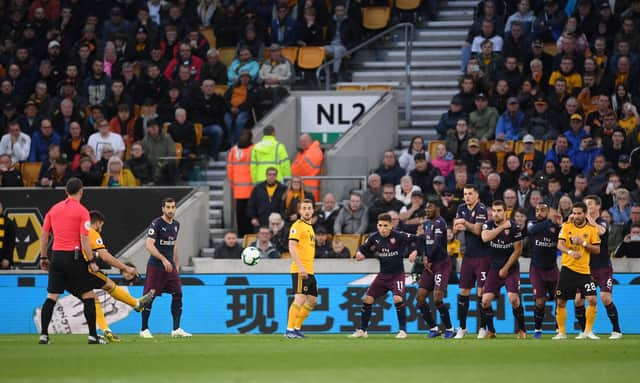 Ruben Neves scores a free-kick for Wolves in their 3-1 victory over Arsenal at Molineux in April 2019.