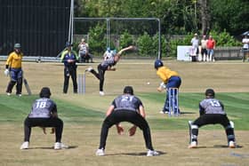 Cricket at Worfield , where Shropshire (in yellow) take on Worcestershire. Worc: Harry Darley, bowls at Connor Marshall.