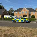 Police vehicles outside a house on Carnoustie Drive, Great Denham, near Bedford