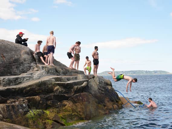People jump into the water at the Forty Foot (Niall Carson/PA)