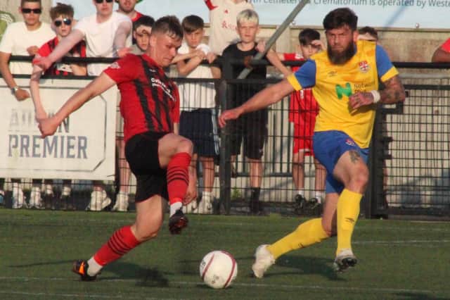 Shane Sutton (yellow shirt) in action for Knighton Town against Porthmadog in the promotion play-off at Park Avenue.
