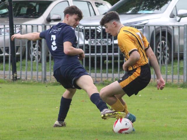Kieran Bounds (navy blue shirt) of Radnor Valley attempts to tackle Harry Edwards of Builth Wells during their Lock Stock Ardal North East derby on the Lant Field