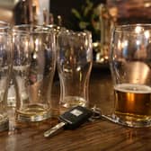 Beer glasses and a set of car keys on a bar in a pub