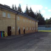 Male detainees looking through the windows of the female unit at Dungavel immigration removal centre in South Lanarkshire