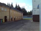 Male detainees looking through the windows of the female unit at Dungavel immigration removal centre in South Lanarkshire