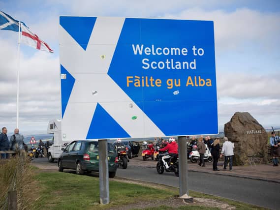 A view of a sign at the Scottish border, which is written in English and Gaelic
