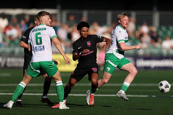Eoin Farrell of The New Saints FC clears the ball from Aaron Malouda of Sabah FK