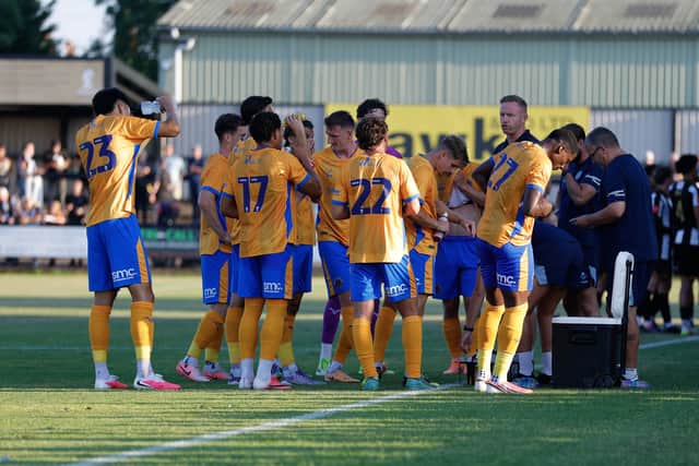 Gavin Cowan speaks with his Shrewsbury Town players during the hydration break
