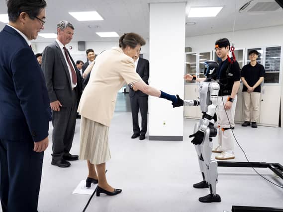 The Princess Royal shakes the hand of a robot during a visit to the Jung Woonoh IT & General Education Centre on the on the Seoul campus of Korea University