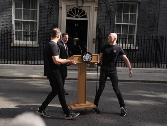 A lectern is moved into position outside 10 Downing Street on June 22 2026, the day Sir Keir Starmer announced his intention to resign as Labour leader and prime minister