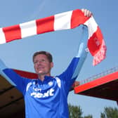Newly appointed Nottingham Forest manager Oliver Glasner holds a red and white scarf aloft at the City Ground