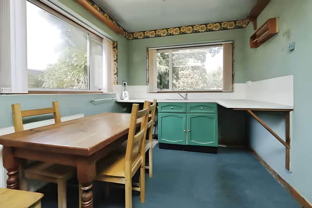 The spacious kitchen and adjoining utility room provide a practical starting point for a future renovation.