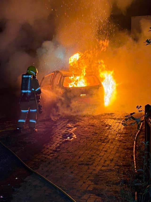 Firefighters tackling the car blaze in Broseley