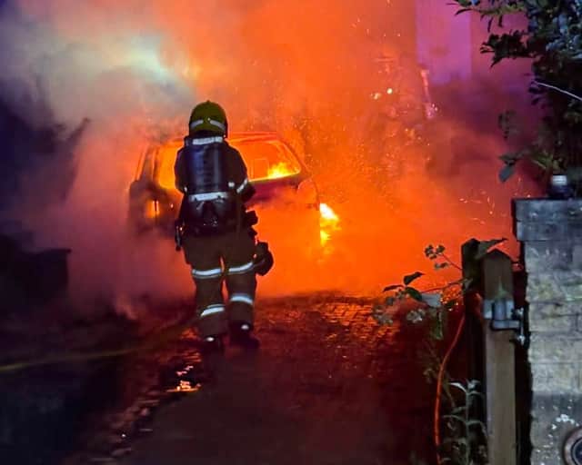 Firefighters tackling a car blaze in Broseley
