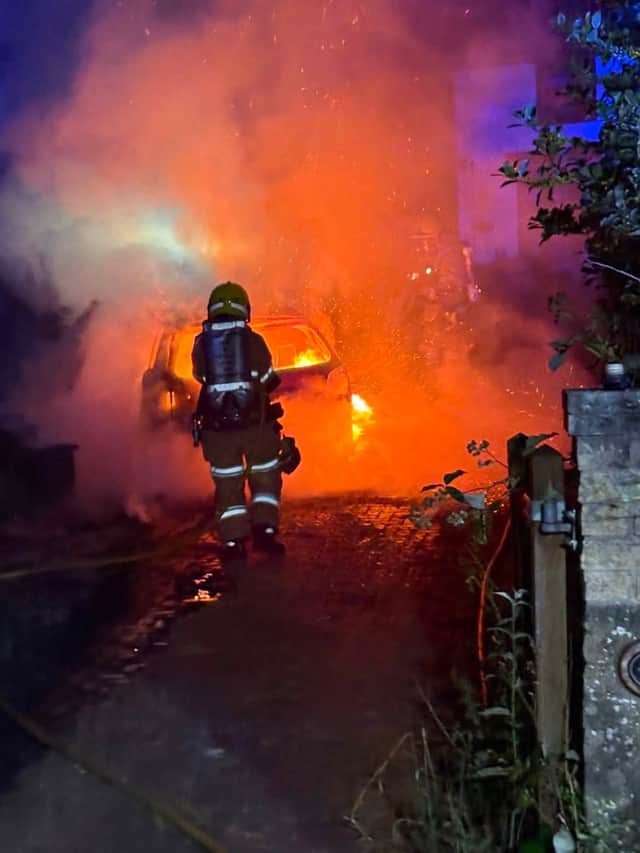 Firefighters tackling the car blaze in Broseley
