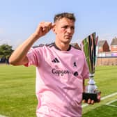 Alex Fletcher celebrates with the Wyn Pryce Trophy