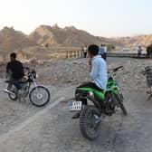 People stand on a bridge destroyed after a strike in Hormozgan province, southern Iran (Amirhosein Khorgooi/Iranian Students’ News Agency via AP)