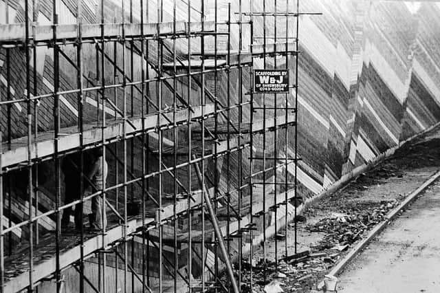 Workers put the finishing touches to the tiled wall in October 1981