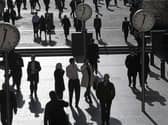 Shadows and silhouettes of pedestrians walking through Reuters Plaza, Canary Wharf, London, UK