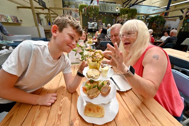 Ellesmere Market Hall that has had new investment , new people running it, new traders, and is now buzzing.  Enjoying afternoon tea: George 10 , Lilly 11, Anthony Hoare, Julie Hoare.