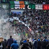 A firework is launched between Celtic and Rangers fans