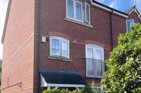 A private driveway and end-of-row position give this versatile Shrewsbury townhouse an appealing first impression.