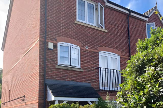 A private driveway and end-of-row position give this versatile Shrewsbury townhouse an appealing first impression.
