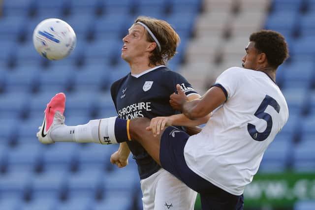 Josh Davison battles for the ball for Shrewsbury Town