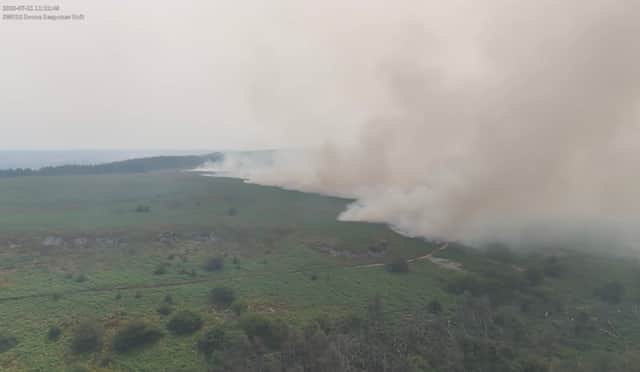 Dramatic drone footage shows the huge scale of a wildfire covering nearly 200 acres in Wales.