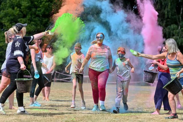 Much Wenlock Primary School colour run. Executive Head Rachel Howell-James runs the gauntlet with: Eli 11 and Ruby 9